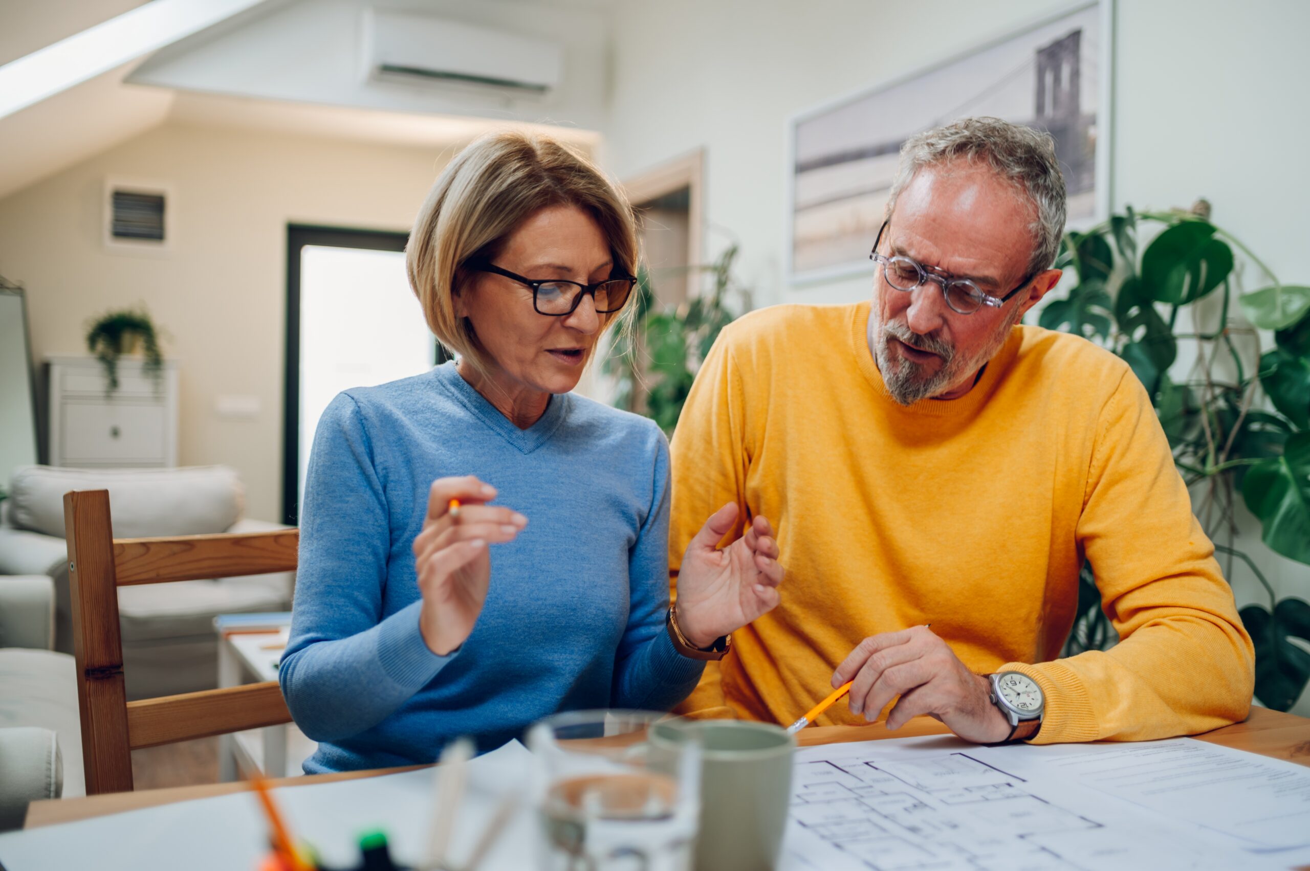 Married,Senior,Couple,Discussing,A,Plan,Of,A,New,House